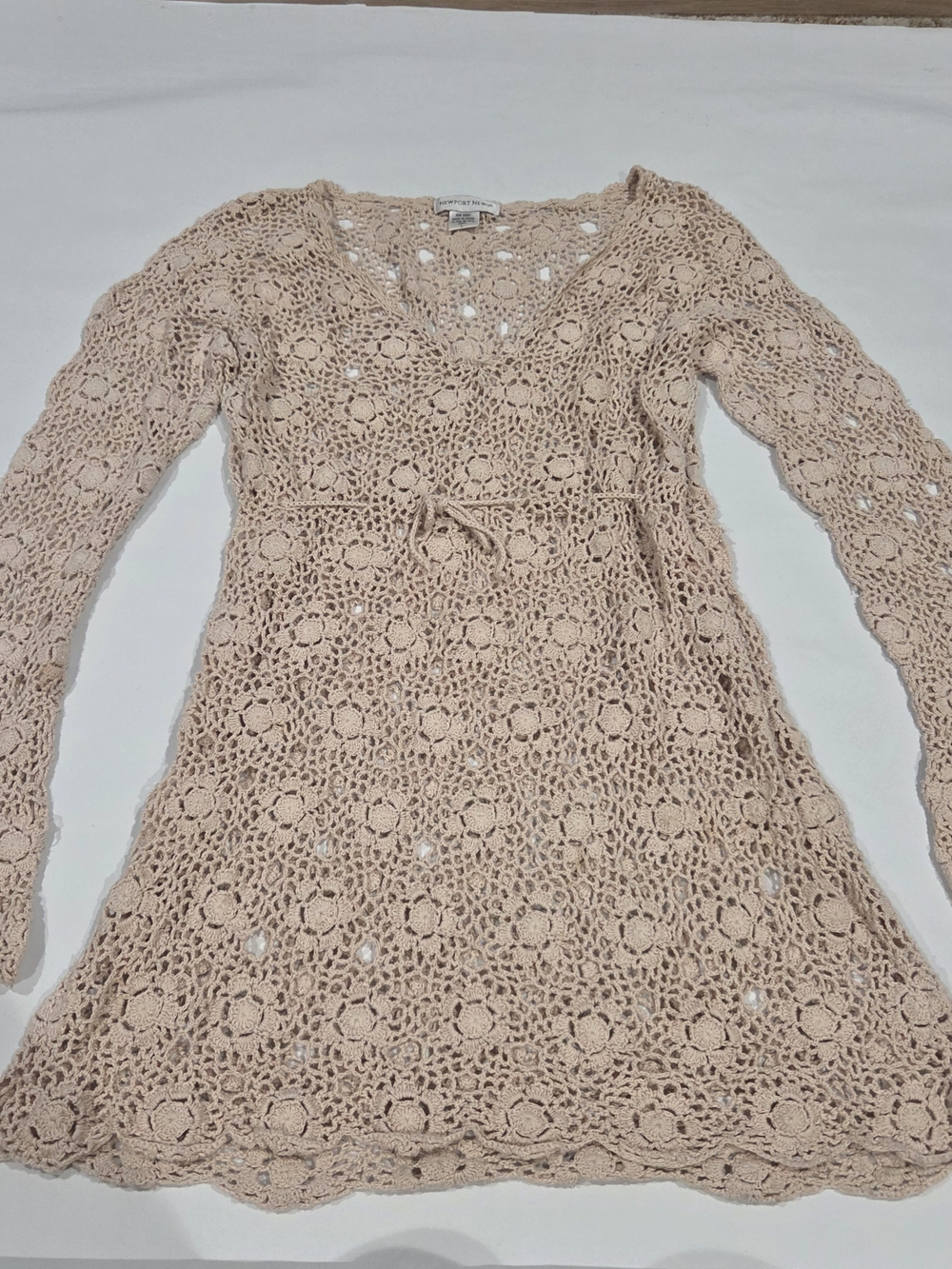 vintage Newport News beige crochet dress with bell sleeves and tie back.